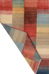 Orientmattor Gabbeh 65015 design carpet showcasing intricate geometric patterns and warm earthy tones on a woven surface.