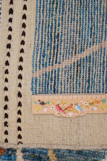 Handwoven Gabbeh rug Moracco No.65989 by Orientmattor, showcasing intricate patterns and rich, earthy colors in natural light.
