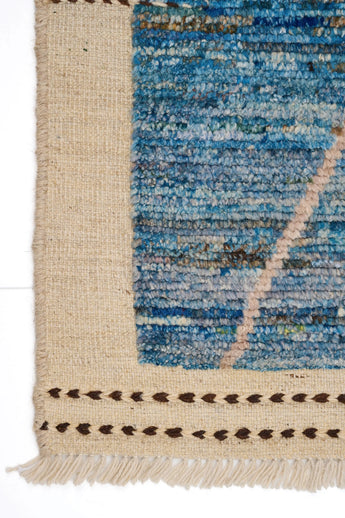 Handwoven Gabbeh Moroccan rug by Orientmattor with intricate geometric patterns in warm earthy tones.