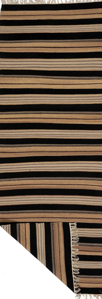 Kelim Dhurrie rug by Orientmattor with intricate geometric patterns in warm earthy tones, woven texture visible in the image.