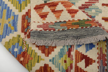 Colorful Orientmattor Kelim Chobi 64647 rug with intricate geometric patterns on a neutral background.