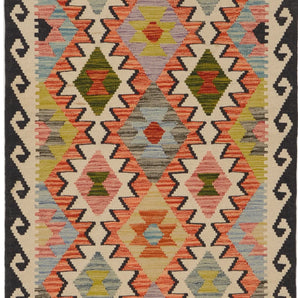 Orientmattor Kelim Chobi 64651 woven rug with geometric patterns and rich earthy tones on a wooden floor.
