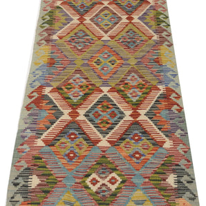 Orientmattor Kelim Chobi 64737 rug with intricate geometric patterns in warm earthy tones, woven with traditional craftsmanship.