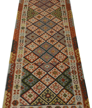 Orientmattor Kelim Chobi 64743 rug with intricate geometric patterns and warm earthy tones, traditional handwoven design.
