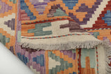 Colorful Orientmattor Kelim Chobi 64972 rug with intricate geometric patterns on a woven textile surface.