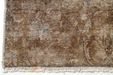 Vintage Orientmattor 60981 area rug with intricate pattern in warm tones, displayed on a wooden floor.