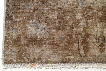Vintage Orientmattor 60981 area rug with intricate pattern in warm tones, displayed on a wooden floor.