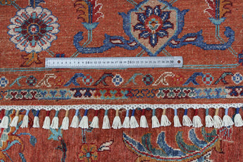 Orientmattor Ghazni 64979 Ziegler/Kazak rug with intricate geometric patterns and rich earthy colors on a woven textile background.