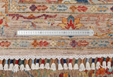 Orientmattor Ghazni 64981 Ziegler/Kazak rug with intricate patterns in earthy tones, displayed on a wooden floor.