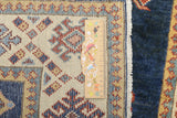 Orientmattor Kazak-Super Ziegler/Kazak rug with intricate geometric patterns and warm earthy tones, detailed close-up view.