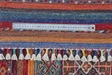 Colorful Ziegler/Kazak Khorjin rug by Orientmattor featuring intricate geometric patterns and vibrant fringed edges.